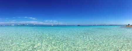 Beatiful Sunny Beach day in Formentera Spain in the middle of the holiday summer season.の写真素材