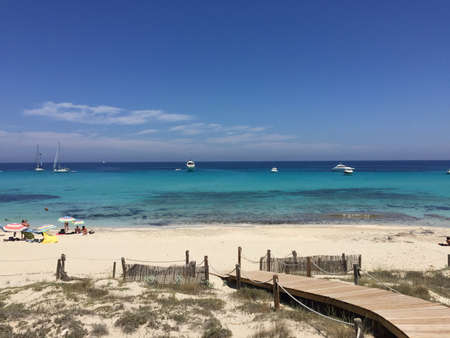 Beatiful Sunny Beach day in Formentera Spain in the middle of the holiday summer season.の写真素材