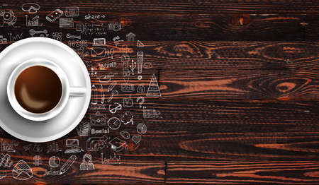 Infograph background template with a fresh coffee on real wooden table with infographic design elements and mockups and hand drawn sketches of technology items.の写真素材