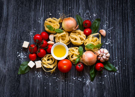Top view of all the necessary food component to make a classic italian pasta with tomato sauce with basil and olive oil!の写真素材