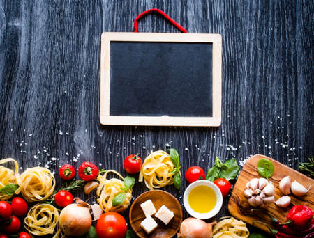 Top view of all the necessary food component to make a classic italian pasta with tomato sauce with basil and olive oil!の写真素材