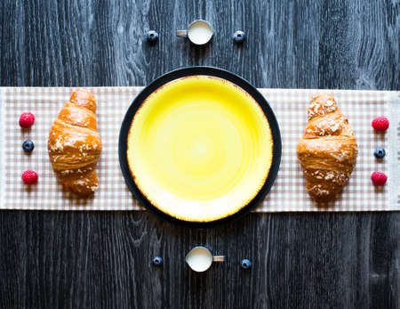 Top view of a wood table full of cakes, fruits, coffee, biscuits, spices and more breakfast classic sweet foods.の写真素材
