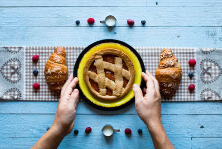 Top view of a wood table full of cakes, fruits, coffee, biscuits, spices and more breakfast classic sweet foods.の写真素材
