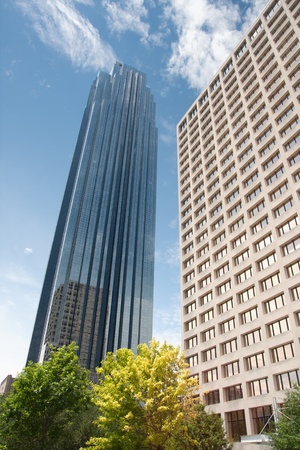 Skyscraper against blue sky and cloudsの写真素材