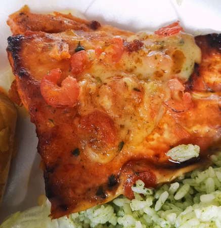 Detail of a chicken breast dish cooked or seasoned in shrimp sauce accompanied by healthy and...