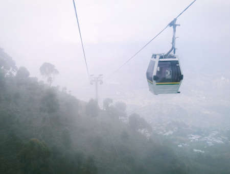 Medellin metrocable cabin (cable car) going to ArvÃ­ Park, a cloudy day, with a view of the cable and the towers. Inclusive mass transportation. Medellin Colombia.の写真素材