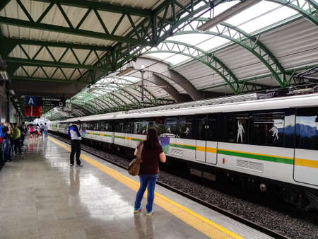 Medellin, Antioquia, Colombia; 06/26/2017: Platform of the Universidad Station of Metro de MedellÃ­n (Colombia) with people waiting for the arrival of the train. Detail of the metro and the wagons.のeditorial素材