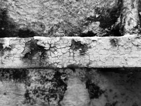 Black and white background texture of a metal aged and oxidized by environmental erosion and weathering with rusty theme and cracked wall.の写真素材