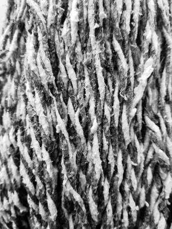 High contrast detail in black and white of yarn from a traditional mop to clean floorsの写真素材