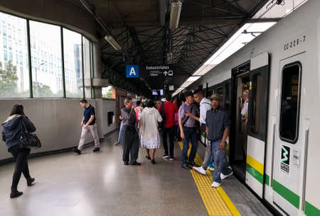Passengers of the Metro of Medellin in rush hour entering and leaving the train, located in the Industrial station of the transport systemのeditorial素材