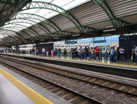 Platform of a station of the Medellin Metro, Colombia. View of the architecture of the building, with perspective and passengers waiting.のeditorial素材