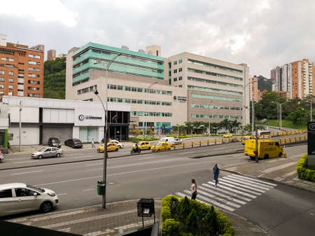 Avenue and modern buildings in the city of Medellin, Colombia. Medical center, taxis, armored cash transport car and apartment buildings.のeditorial素材