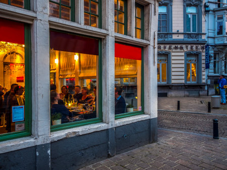 Restaurant with happy people in the evening at the Burgstraat, Ghent, Flanders, Belgium, Europeの写真素材