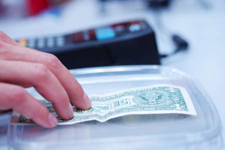 Man paying with money in the shop.の写真素材