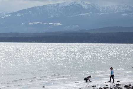 girls playing on a sandy baech near Comox, Vancouver Island, BC, Canadaのeditorial素材
