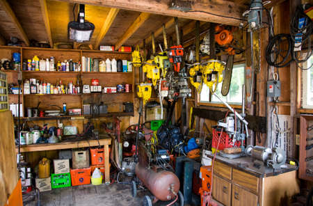 old workshop shed with equipment, power tools and suppliesのeditorial素材