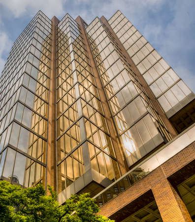 golden skyscraper at sunset, Axa Place, Vancouver, BC. HDR image.のeditorial素材