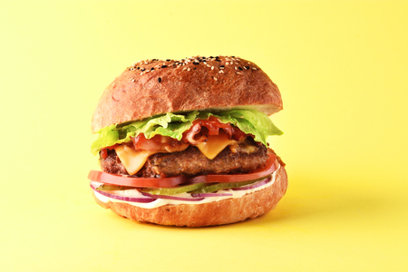 Fresh juicy burger on yellow backgroundの写真素材