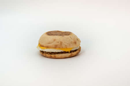 egg sandwish with sausage and cheese on white background