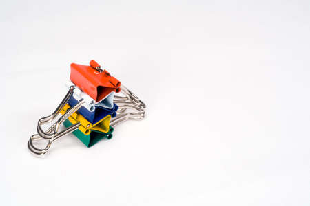 Colorful paper clips stacked neatly in a pile.の写真素材