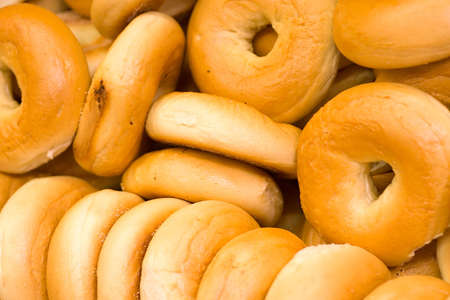 A pile of bagels in a grocery store.の写真素材