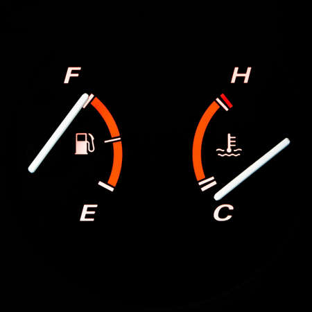 Detail from a glowing car dashboard: fuel and engine temperature guages.の写真素材