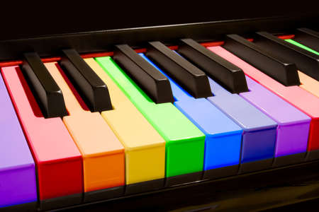 Color isolated piano keys in the colors of the rainbow.の写真素材