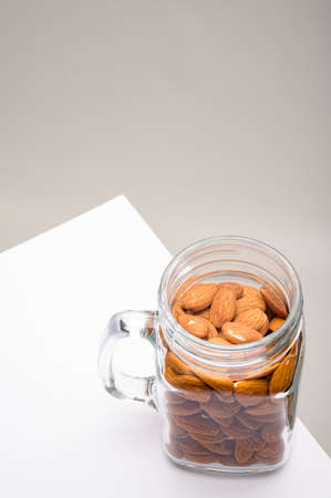 Glass jar filled with a variety of nutrition and healthy snacks and nutsの写真素材