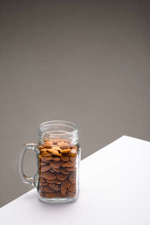Glass jar filled with a variety of nutrition and healthy snacks and nuts