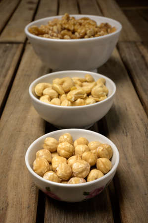 walnuts, hazelnuts, cashew nuts, bowl, bowls, wood, board, table,