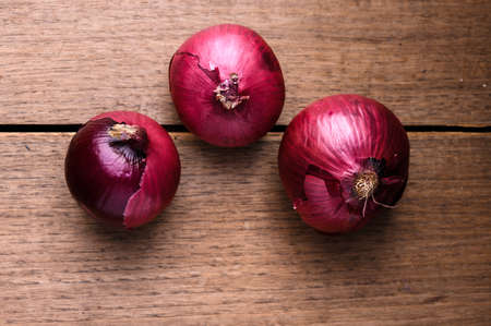 Freshly picked onions on top of a wooden tableの写真素材