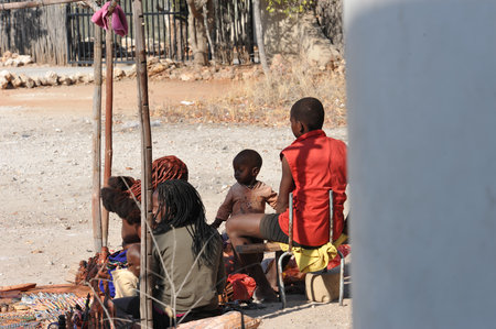 Unidentified boys sit in the street.