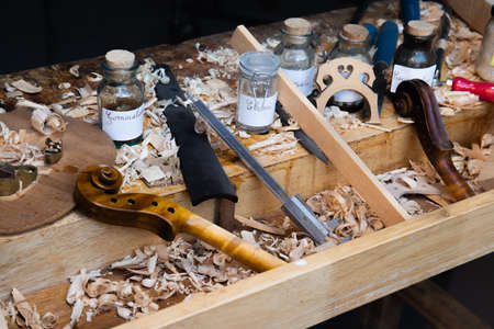 The old bench of violin makers in a workshop of a luthier