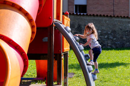 little girl plays on the playgroundの写真素材
