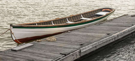 Wooden boat tied up at a pier in Washington DCの写真素材