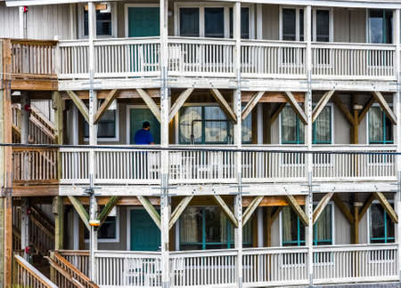 December 27, 2017: Atlantic Beach North Carolina, US-Man in a maze of wood at a beach condo in North Carolina coast in front of doorのeditorial素材