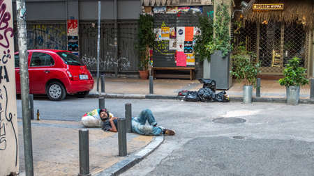 Athens Greece/August 17, 2018: Homeless man sleeping on the streets of Athens using bag as pillowのeditorial素材