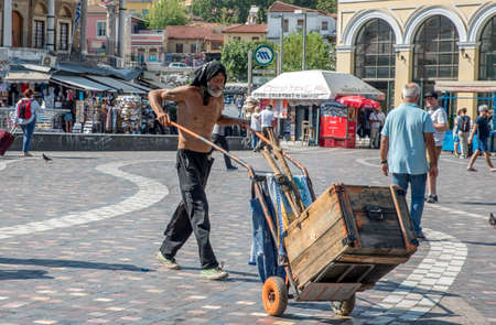 Athens Greece/August 17, 2018: Homeless man pushing cart through Monistiraki Square Athensのeditorial素材