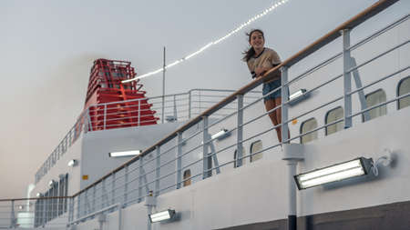 Teen on deck of ferry boatの写真素材