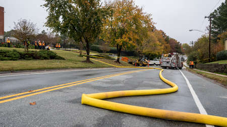 Carrboro, NC, US- November 5, 2018:  Firemen and Water Authority workers repairing a broken water...