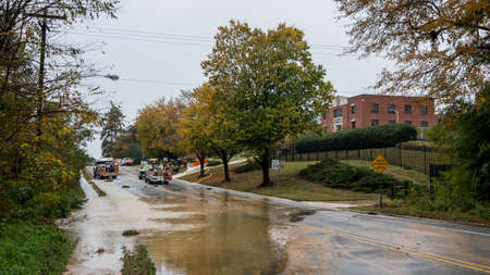 Carrboro, NC, US- November 5, 2018:  Firemen and Water Authority workers repairing a broken water mainのeditorial素材