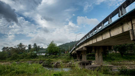 The bridge at Kiriwong Thailand stretching across the river