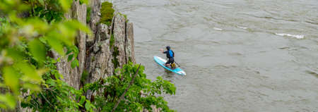 Man on Kayak in wetsuit on kayak on the river at Great Falls National Park, Virginia
