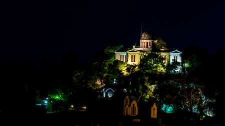 The National Observatory Athens Greece lit up at night with colorful lightsの写真素材
