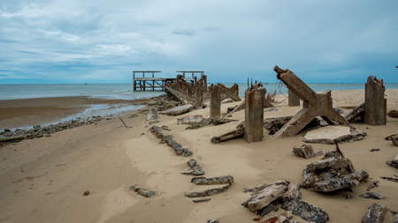 Dilapidated old fishing dock collapsing into the sea in Pak Nam Pran on the Gulf of Thailand in Thailandの写真素材