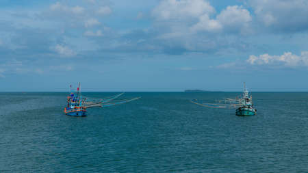 Two traditional Thai fishing boats with outriggers out near Pythiu