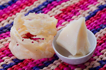 a parmesan cheese basket with a scale of parmesanの写真素材