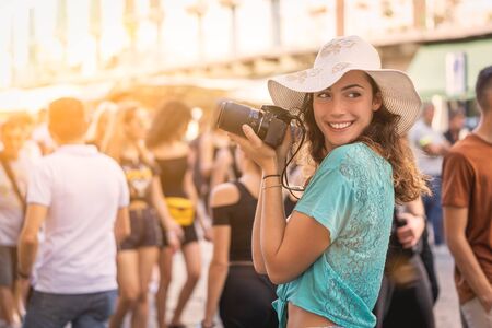 Girl tourist or professional photographer who shoots in a typical Italian city.の写真素材