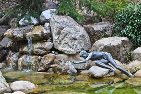 This good decision of landscape design. A combination, a stone, water and a sculpture.の写真素材