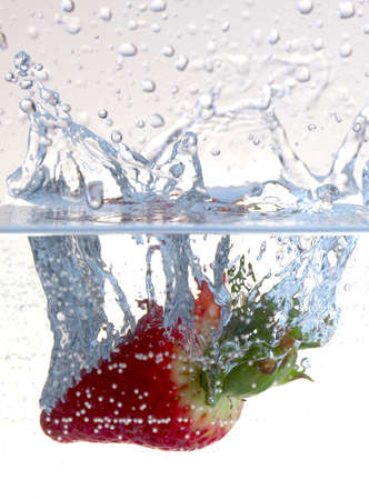 Water splashing on a strawberryの写真素材